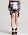 A newsprint-style pattern and asymmetric hem infuses this Helmut Lang skirt with edgy-cool sophistication.