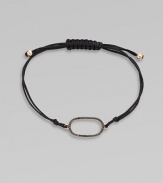 A knotted cord with a black diamond encrusted, 18K rose gold, oval link. Black diamonds, .25 tcw18K rose goldPolyester cordLink size, about ¾Length, about 13½ adjustableDrawstring closureImported 