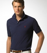 Short-sleeved polo shirt cut for a comfortable, classic fit. Breathable, durable cotton mesh. Two-button placket. Ribbed polo collar and armbands, uneven vented hem. Embroidered pony accents the chest.