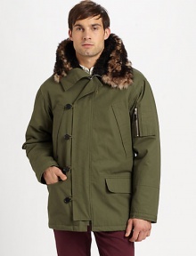 A modern interpretation of a classic style, this military style parka jacket exudes city-cool featuring zippered pockets on the sleeve and an attached faux-fur lined hood.Zip frontButton-front placketAttached faux-fur lined hoodWaist flap pocketsAbout 31 from shoulder to hemCottonDry cleanImported