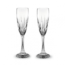 Beveled cuts of varying heights add grandeur to Baccarat's Juputer Champagne flutes.