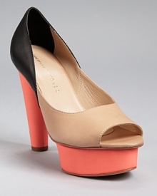 Unassuming nude and black get a dose of color with the addition of a bright coral platform and heel. A color block design feels right on trend--pair these covetable pumps with a monochromatic outfit for an of-the-moment look. From Loeffler Randall.