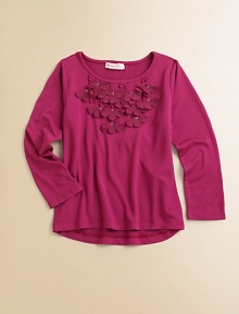 Rows of ruffles and rosettes line the neckline of this plush, long-sleeved pullover.ScoopneckLong sleevesPullover styleHi-lo hem60% rayon/40% cottonHand washImported