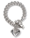 A crown-embossed heart locket on chainlink bracelet with bow toggle closure from Juicy Couture.