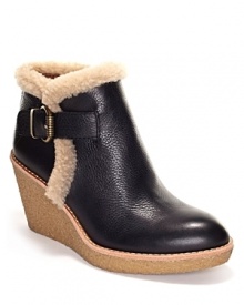 Shearling adds a cozy touch to chic, pared-down wedges from Sam Edelman. A neat, sleek buckle finishes the look.