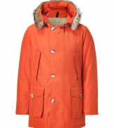 Stylish and sporty rust down coat in a washable cotton blend from the American heritage label Woolrich - Tapers slightly at waist, hits at mid-thigh - Rabbit fur collar lends this coat a veritable feeling of warmth and luxe - Water and snow resistant, with multiple pockets and hood - Exceptionally warm, can be worn in temperatures as low as -30 F - A versatile, classic coat perfect for both city streets and country slopes