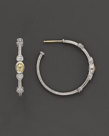 Faceted, oval-shaped canary crystals, flanked by hearts, bring romantic glamour to classic sterling silver hoop earrings.