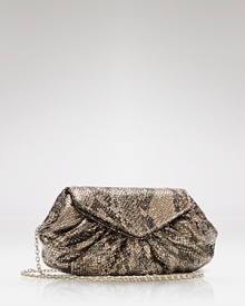 A slender strap snakes across your body, doubles over your shoulder or slithers off completely, giving Laura Merkin's cobra-embossed clutch tempting tactile appeal.