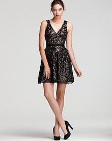 Sparkling sequins peek out from underneath a delicate lace overlay on this BCBGMAXAZRIA dress, finished with a glossy ribbon belt and sultry cutout back.