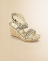 Straps of richly woven raffia with a glowing metallic finish on an of-the-moment rope-covered wedge.Woven raffia upperCrisscross buckle ankle strapRope-covered composite rubber wedge heel and soleMetallic faux leather liningImported