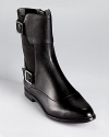 With gored sides, Calvin Klein's Tatiana booties easily come on and off. Shining silver-tone buckles lend a modern look.