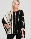 Color-blocked stripes bring statement chic to this Aqua knit poncho. Pair with sleek leggings for a balanced silhouette.