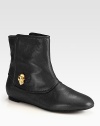 A gleaming goldtone skull adds signature style to this ultra-soft leather ankle boot. Leather upperPull-on styleLeather lining and solePadded insoleMade in Italy