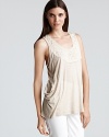 Awake Couture lends a boho-casual touch to everyday wares in this tank with a lace back inset. Tonal fabric neckline embellishments lend feminine charm.