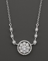 Diamond flower cluster pendant with bezel stations on the chain. Set in 14 Kt. white gold.