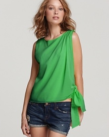 Playful style starts with this silky Alice + Olivia top flaunting a revealing side opening and tie at the hem. Perfect to pair with your favorite cut-off shorts, the silhouette epitomizes summer style.