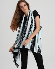 Wrap up your look with this boldly printed poncho-style scarf from DIANE von FURSTENBERG. Fringed edges lend bohemian flair.