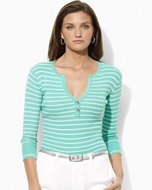 A deep split neckline finished with silver-toned buttons lends modern allure to a classic striped Henley in soft ribbed cotton.