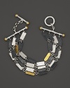 Gold and silver mingle in on his dramatic chain and toggle bracelet from Gurhan.