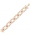 Fit for a princess. 2028's flirty floral design features pink, pear-cut glass accents in gold tone mixed metal. Approximate length: 7-1/4 inches.