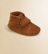 Classic moccasin stitching, fringe and an easy on/easy off grip-tape strap make this plush suede pair a must-have for baby.Grip-tape strap closureSuede upperSuede solePadded insoleImported