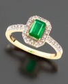 Strikingly beautiful with a bold emerald-cut emerald (3/8 ct.t.w.) surrounded with the beauty of sparkling round-cut  diamonds (1/8 ct. t.w.), all set in 14K yellow gold.