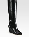 With intricate stitching and a glossy finish, this leather knee-high design has a towering wedge and padded insole. Self-covered wedge, 3 (75mm)Shaft, 15½Leg circumference, 14Leather upperLeather lining and solePadded insoleImported