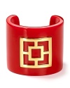 A signature golden Trina Turk brick shines on a bold enamel cuff.