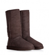 A tried-and-true cold weather staple, these tall classic shearling boots from UGG Australia boast comfort and utilitarian chic - Round toe, rugged rubber sole, exposed seams, cozy shearling lining, back logo detail - Tall shaft height - Pair with skinny jeans, an oversized cashmere sweater, and a down jacket or wool cape