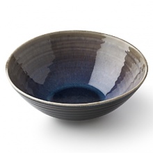 Subtle gradations of blue and beige make each piece of this glazed dinnerware unique and alluring.