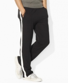 An essential sweatpant is rendered in super-soft fleece with sleek pintucked detailing for stylish comfort on and off the track.