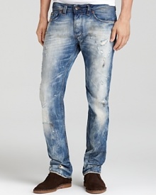 Bleaching and distressing lend effortless edge to these slim-fit, straight leg jeans from Diesel.