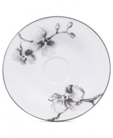 Compose a striking arrangement with the Black Orchid saucer by Michael Aram. Fine white Limoges porcelain flourishes under a dark watercolor motif inspired by foliage from around the world.