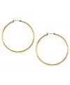 Embellished elegance. Anne Klein adds glass accents to these hoop earrings crafted from gold-tone mixed metal to stunning effect. Approximate diameter: 2 inches.