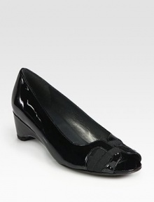 Glassy patent leather go-to fronted by lavish grosgrain ribbon trim. Self-covered heel,  (25mm)Patent leather and grosgrain ribbon upperLeather liningExclusive rubber solePadded insoleImported