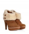 An edgy iteration of the iconic UGG boot, the Georgette guarantees to keep you warm in high style - Round toe, platform, crease-detailed front, shearling cuff with button details, chunky stacked leather high heel, inside zip closure - Ankle height - Pair with skinny jeans, an oversized cashmere sweater, and a down jacket or wool cape