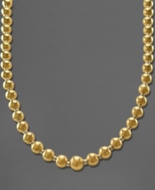 This traditional graduated necklace shines bright with beautiful beads of 14k gold over sterling silver and sterling silver. Approximate length: 18 inches.