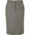 Luxurious skirt in a fine wool and cashmere blend - Features a classic herringbone pattern in black and ecru - Slim, narrow pencil cut with decorative side stripes and small welt pockets with button closure at back - Sophisticated look with a blazer, blouse and heels - Transitions effortlessly from office to evening