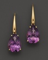 An elegant amethyst drop earring in 18 Kt. yellow gold. With Roberto Coin's signature ruby accents.