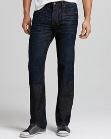 Joe's Jeans relaxed fit jeans in a dark wash features straight legs, a normal rise, worn detailing and contrast stitching. Joe's signature stitching on back pockets.