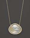 Diamonds circle a faceted rutilated quartz and mother-of-pearl doublet set in 18K yellow gold. By Di Massima.