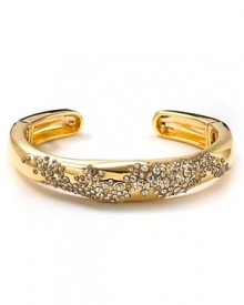 Pavé Swarovski crystals, scattered on a freeform gold cuff, glitter with every move you make. By Alexis Bittar.