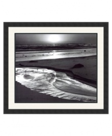 A setting sun illuminates the rippling Pacific below Scripps Pier in this arresting landscape. Tiny seabirds enjoy the view and test a shallow pool left behind by the tide. Photographed by Ansel Adams for the University of California's centennial anniversary and framed in simple satin black.