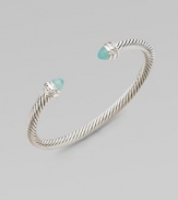 From the Cable Collection. A signature cable design with pretty aqua chalcedony caps accented in sparkling diamonds. Aqua chalcedonyDiamonds, .2 tcwSterling silverDiameter, about 2½Slip-on styleImported 