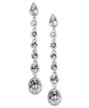 Admirers will line up when you accent your evening wear with luminous linear drops. Givenchy earrings feature round-cut crystals set in silver tone mixed metal. Approximate drop: 1-1/2 inches.