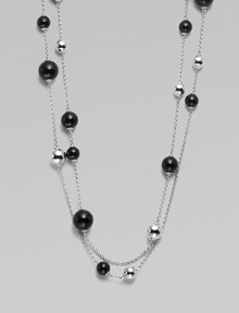 A very long, delicate piece with beautiful round black agate and contrasting sterling silver stations on a link chain, perfect for wearing doubled. Black agateSterling silverLength, about 51Clasp closureImported 