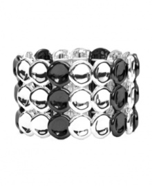 Versatility and shimmer at its best. Monet's trendy three-row style features discs crafted from silver and hematite tone mixed metal. Bracelet stretches to fit wrist. Approximate diameter: 2-1/4 inches.