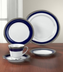 Formal white fine china displays a dramatic combination of scrolling leaves on shimmering platinum and an inner band of intense cobalt blue. Dishwasher safe.