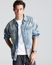 An elegantly wasted denim shirt with distressing, bleaching and plaid patches for that artist-in-residence look.