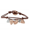 Live it up with free-spirited style from Fossil. This totally charming bracelet features a chocolate leather cord strung with sparkling crystal heart charms in rose gold tone and silver tone mixed metal. Includes a button closure. Approximate length: 7-3/4 inches.